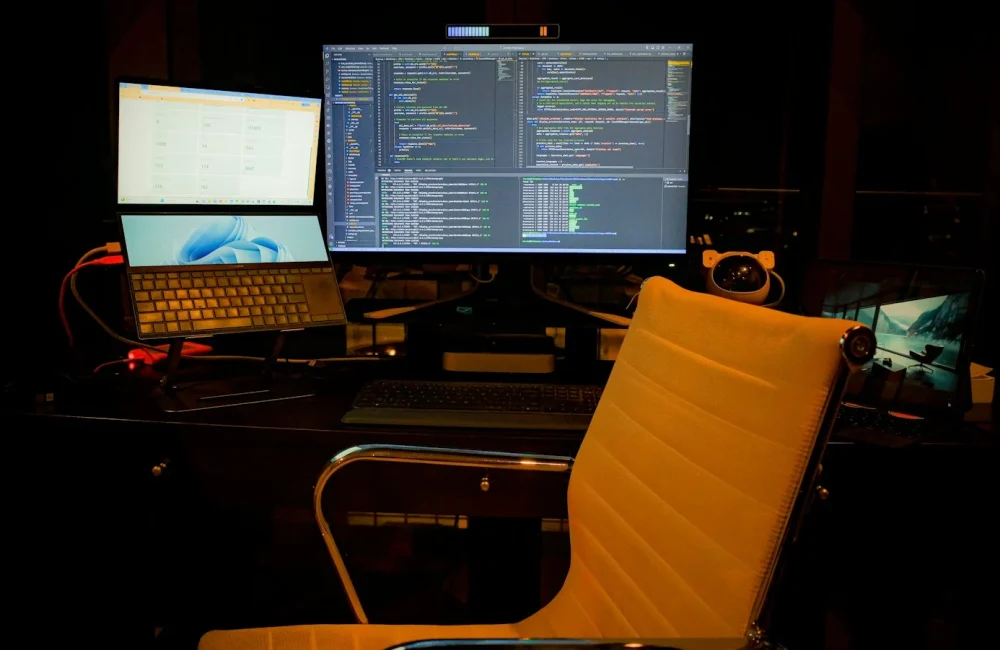 Mesa de trabajo con dos monitores y un portátil